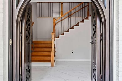 Stairway with baseboards, marble finish floor, and