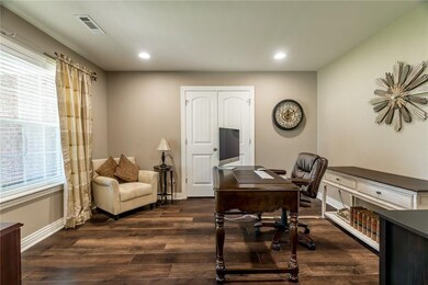 The study with storage closet overlooks the front yard.