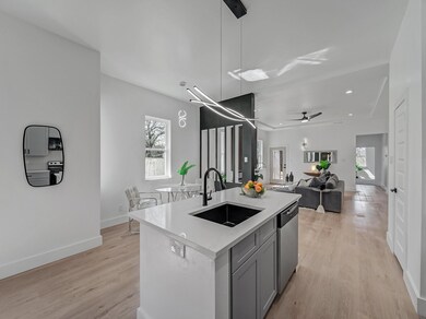 Kitchen featuring light countertops, light wood-ty