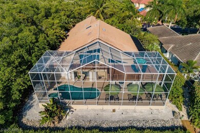 Aerial Back of Home, showing large lanai/pool/outdoor living all under screen