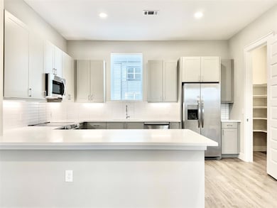 Kitchen with stainless steel appliances, sink, kit