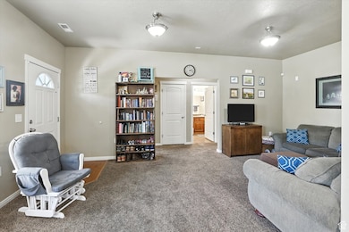 Carpeted living room featuring baseboards