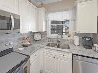 Kitchen featuring backsplash, crown molding, stain