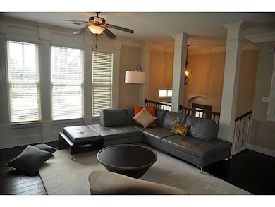Living room with decorative columns, wood finished