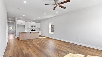 Kitchen featuring a wealth of natural light, stain