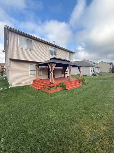 Rear view of house featuring a yard and a deck