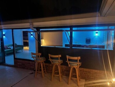 Outdoor access to bar with a sink, drink refrigera