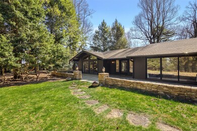 Stone path leads from driveway to front of home