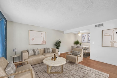 Living area featuring a textured ceiling, wood fin