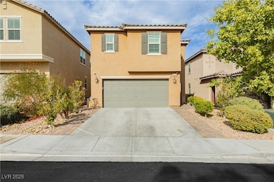 View of front facade with stucco siding, concrete driveway, a tile roof, and a garage