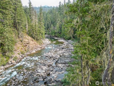 Breathtaking high-bank views of the Cle Elum River surrounded by evergreens and mountain scenery.
