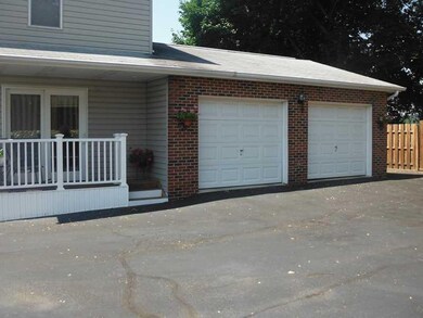 Exterior Back. Side porch and 2+ car garages (24  