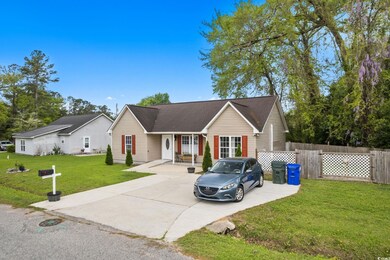 Ranch-style house with a front yard, fence, and ro
