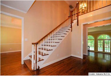 Two story foyer opens to formal dining room on lef