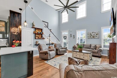 Living room featuring wood-type flooring, a high c