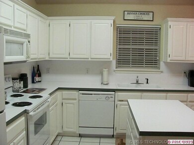 Kitchen has center Island and lots of cabinets.