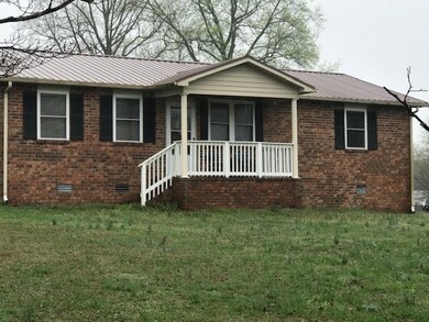 Close up view full brick, metal roof, tilt windows!