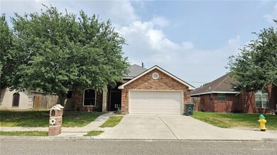 View of front of property with a garage and a front yard