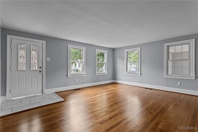 Foyer entrance featuring visible vents, hardwood /