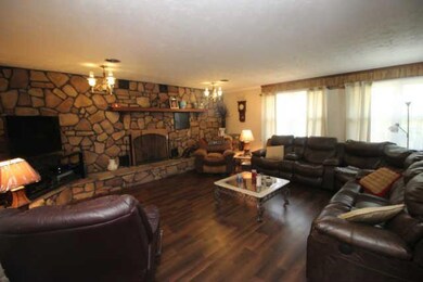 Spacious Family room with fireplace and lots of natural light. new flooring