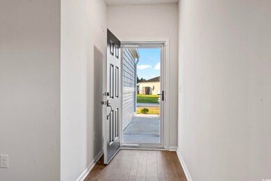 Doorway to outside featuring dark wood-type floori