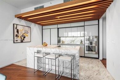 Poliform kitchen with marble island in Calacatta g