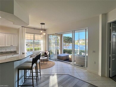 Dining room with a water view and light tile patterned floors