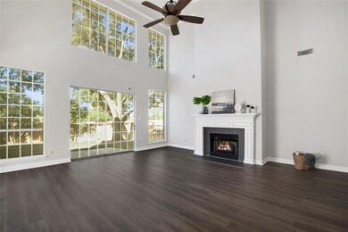 iving room featuring a tile fireplace, a high ceil
