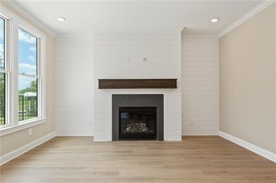 Unfurnished living room featuring baseboards, crow