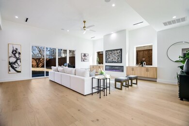 Living room featuring ceiling fan and light hardwo