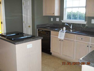 Kitchen has island with cooktop.