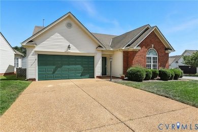 View of front of house with driveway, an attached garage, roof with shingles, and a front lawn