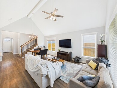 Living room with beam ceiling, arched walkways, ce