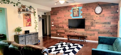 Living area with wooden walls, wood finished floo