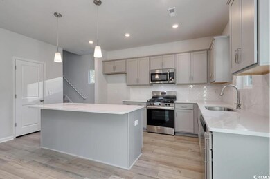 Kitchen with light hardwood / wood-style flooring,