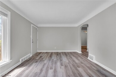 Spare room featuring a healthy amount of sunlight and wood-type flooring