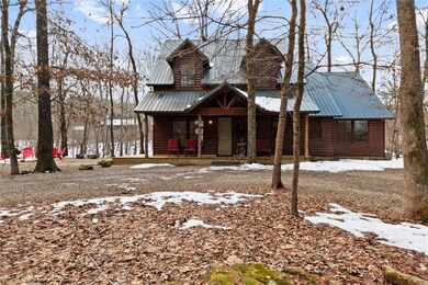 Log-style house featuring covered porch