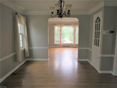View from dining room with cove ceiling and chair 