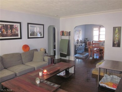 Living room featuring crown molding and hardwood / wood-style floors