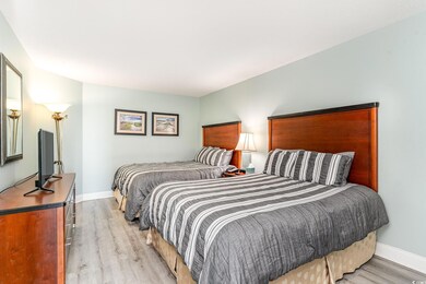 Bedroom featuring light hardwood / wood-style floo