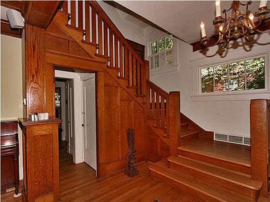 Entry foyer with handcrafted woodwork of an era go