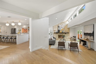 Living area featuring a fireplace, light wood-typ