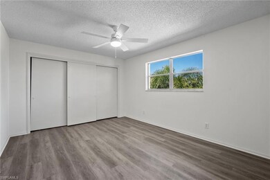 Unfurnished bedroom with ceiling fan, a closet, light hardwood / wood-style flooring, and a textured ceiling