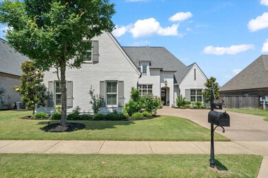 French country inspired facade featuring brick siding