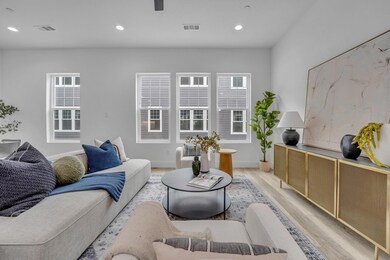 Living room featuring visible vents, a healthy amo
