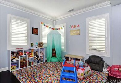 Another look at the Living Room at the entrance of the home will immediately give you an idea of how chic this Preserve home is. Upgraded design elements include crown molding, recessed lighting and wood plantation shutters.