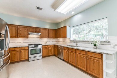 The kitchen has granite countertops with stainless
