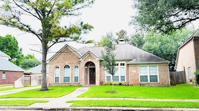 well-maintained front lawn and mature trees. Featu