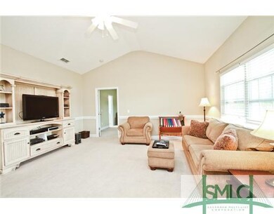 Living Room. Cathedral Ceiling and Lots of Natural