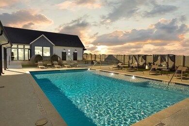 SPACIOUS RESORT STYLE POOL WITH FLOATING SEATS (NOT SEEN), LOUNGE AND CABANAS!